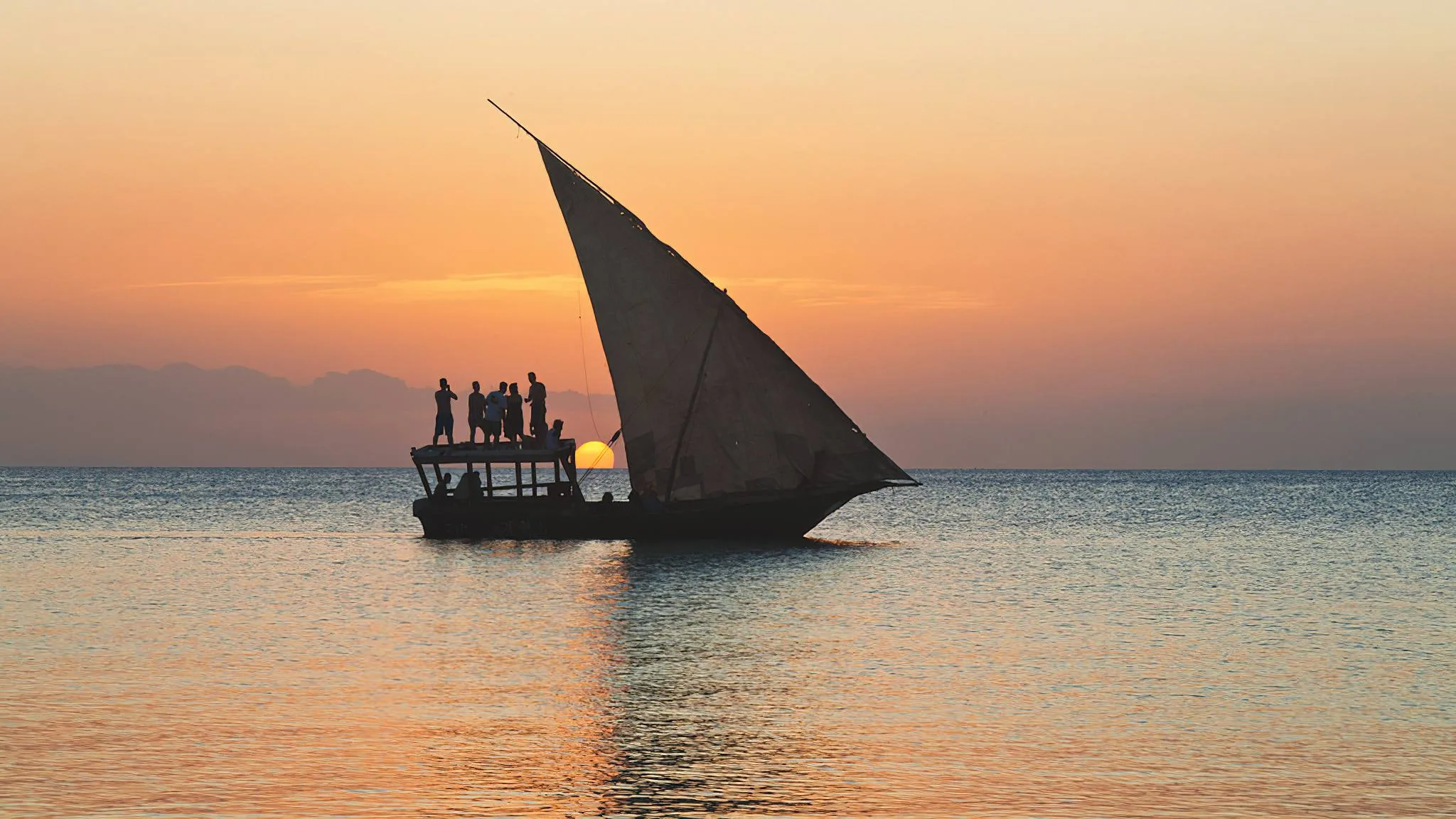 Traditional Swahili dhow boats anchored in Fumba, Zanzibar, preparing for the Safari Blue excursion.