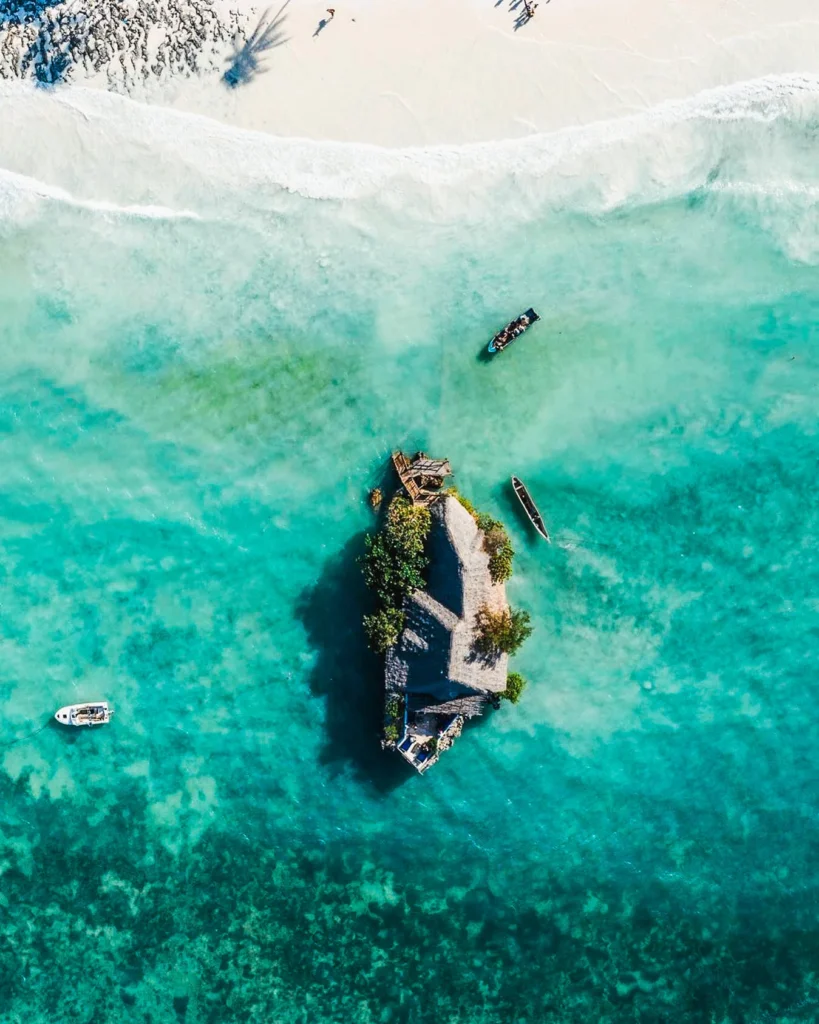 Request a Zanzibar Vacation Free Quote The Rock Restaurant Zanzibar surrounded by ocean at high tide.