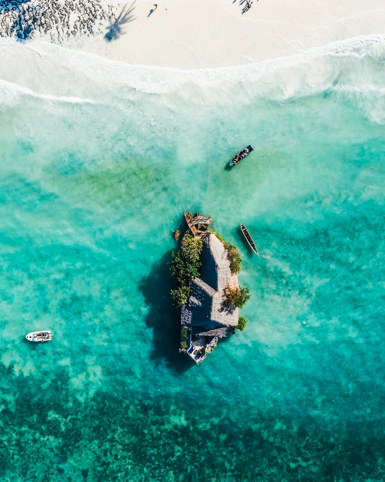 The Rock Restaurant Zanzibar surrounded by ocean at high tide.